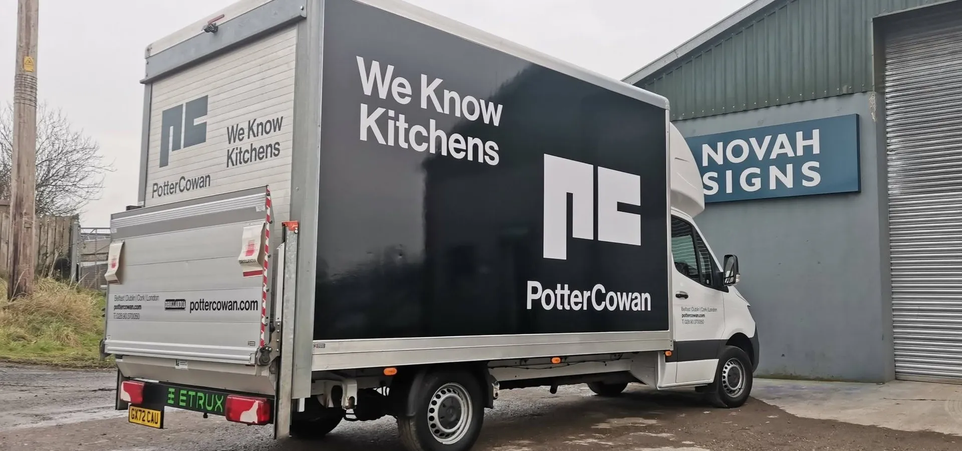 Potter Cowan box truck with a full vehicle wrap reading We Know Kitchens, photographed outside the Novah Signs workshop.