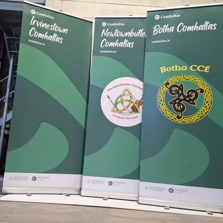Three roll-up banners for Comhaltas branches (Irvinestown, Newtownbutler and Botha) finished in green branded artwork.